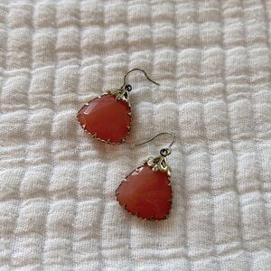 Peach earrings with gold details (possibly Kendra Scott)